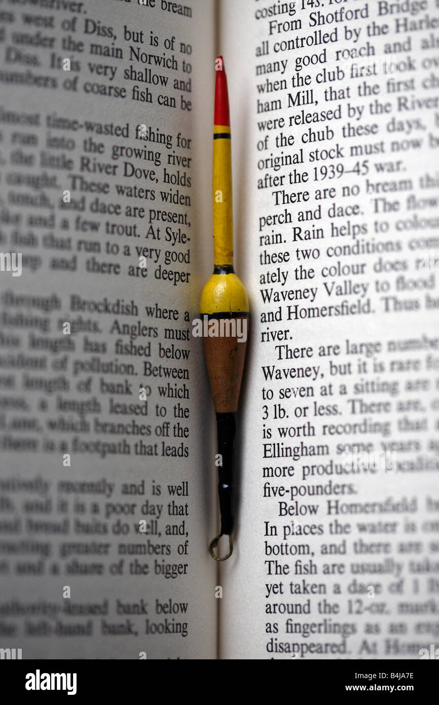 Vintage fishing float, nestled between the pages of old book on