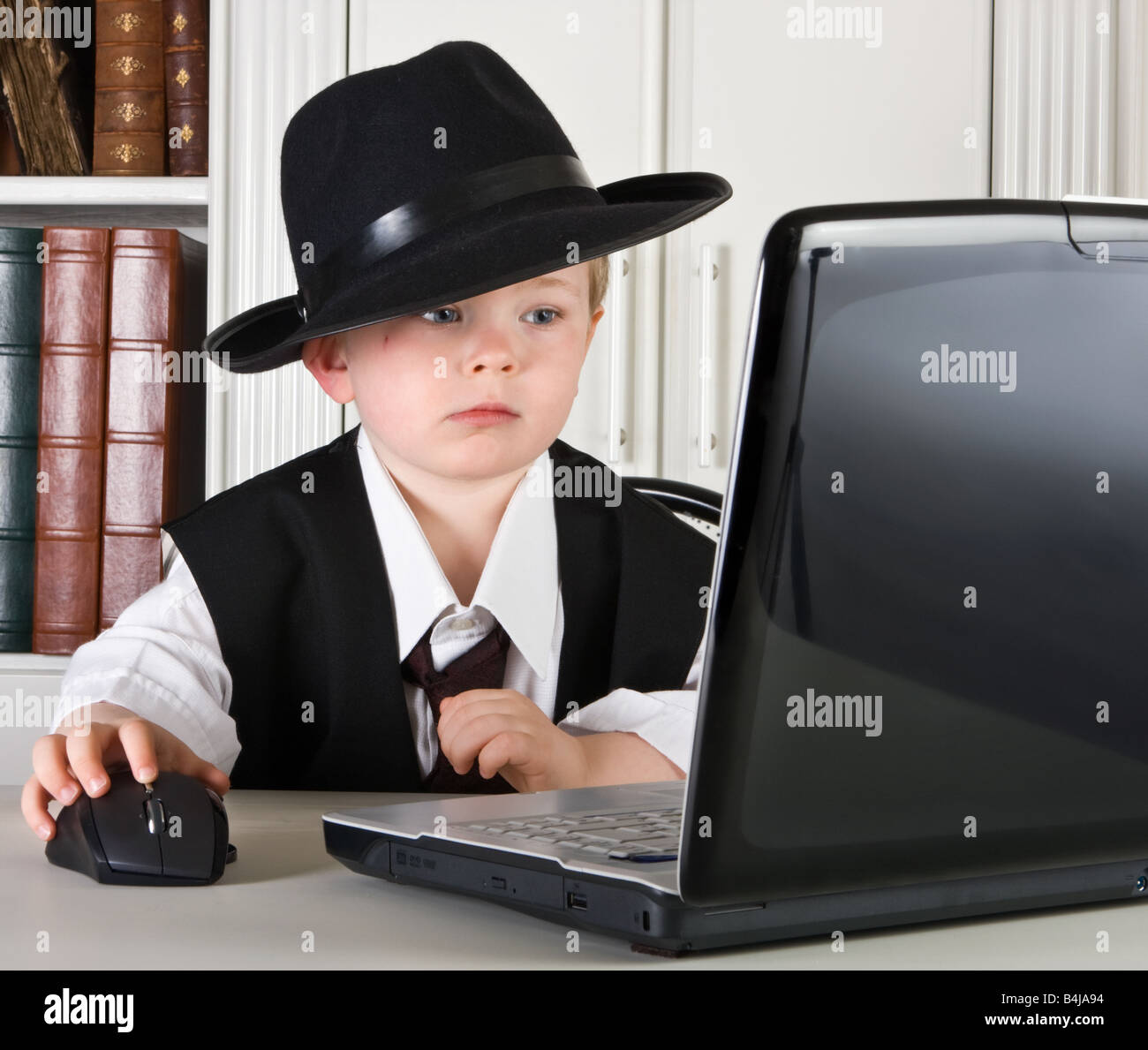 Four year old boy playing director in his office Stock Photo