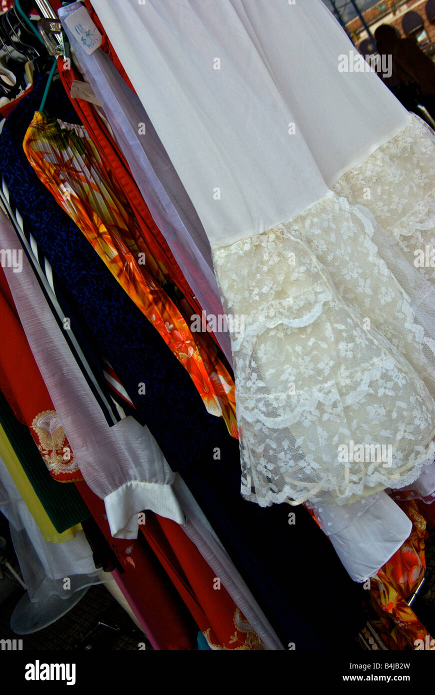 Second hand consignment clothing store sidewalk display of dresses on