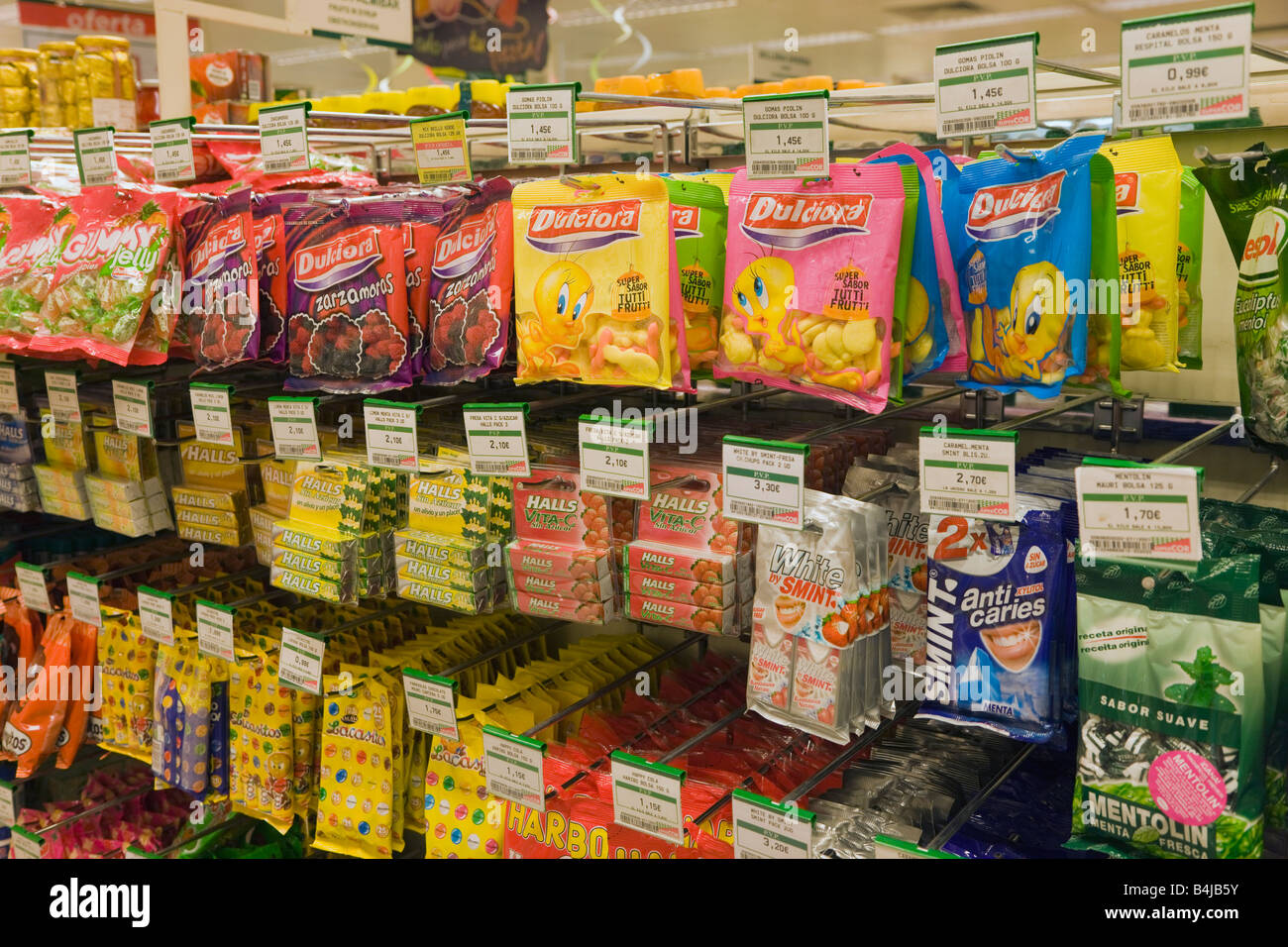 Packets of confectionery on supermarket shelves in a SuperCor outlet of El Corte Inglesa Spain Stock Photo