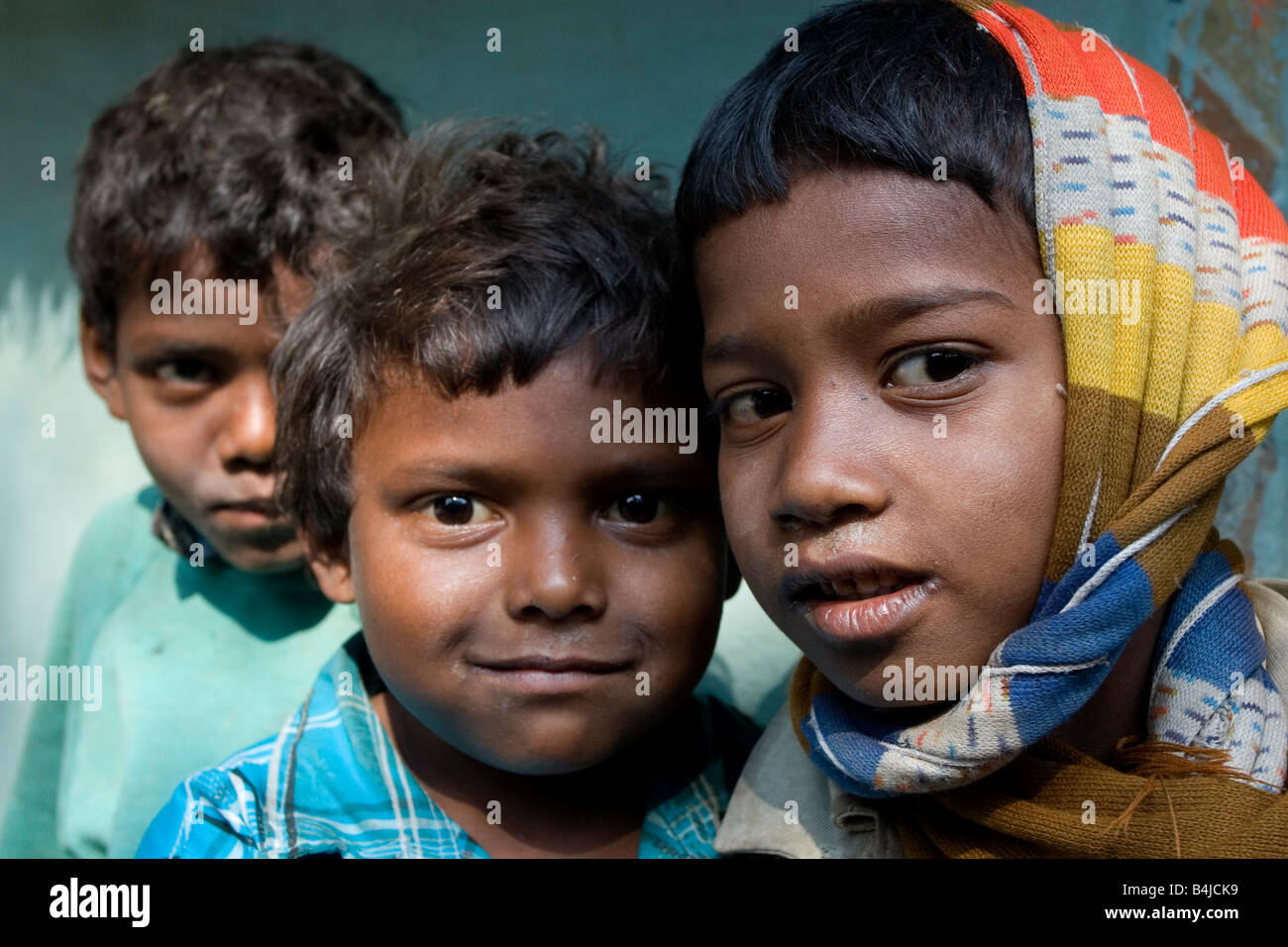 Three tribal boys shares a happy moment at a tribal village of West ...