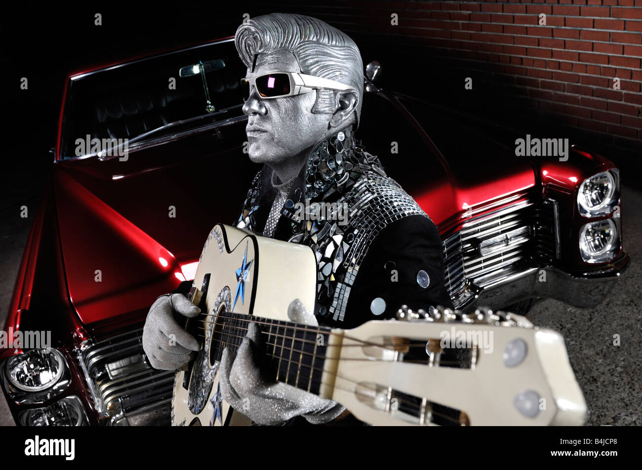 License and prints at MaximImages.com - Silver Elvis with a guitar and a classic retro american car Stock Photo