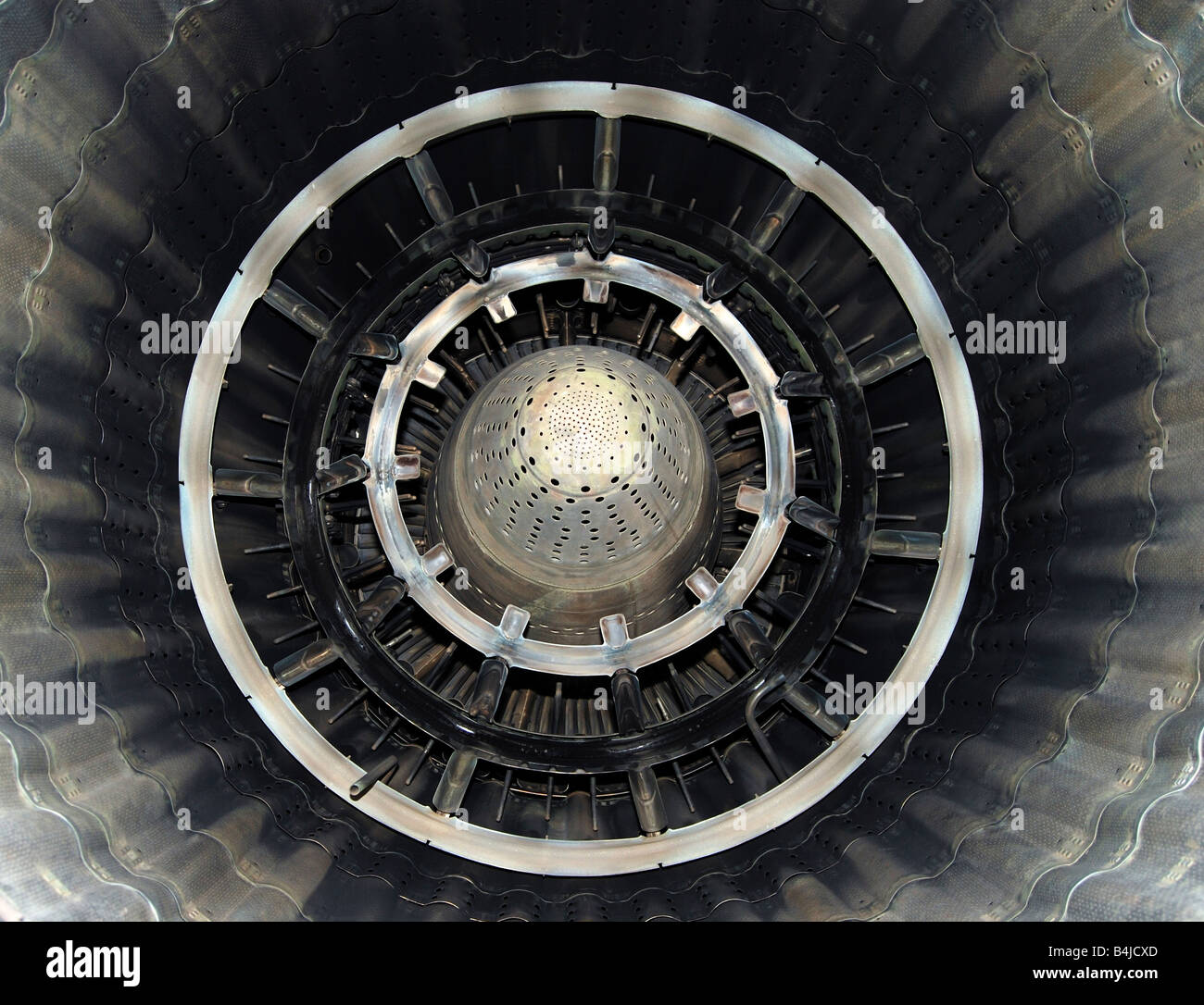 Turbine of military airplane from within, close up, metallic blades and circles, shining symmetric patterns Stock Photo