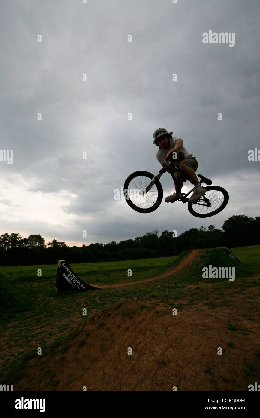 BMX biker performing tricks and jumping a large ramp Stock Photo Alamy