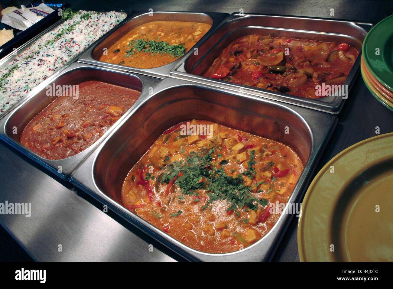 Curries awaiting serving in a canteen servery bain marie Stock Photo