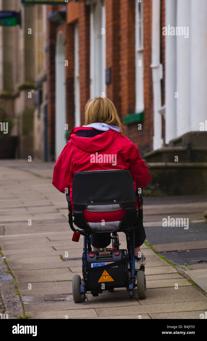 lady riding electric scooter on pavement UK Stock Photo Alamy