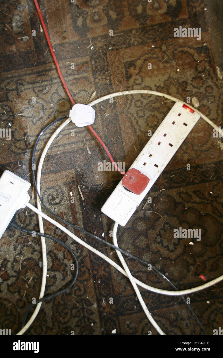 electricity plugs and extension lead dirty carpet Stock Photo Alamy