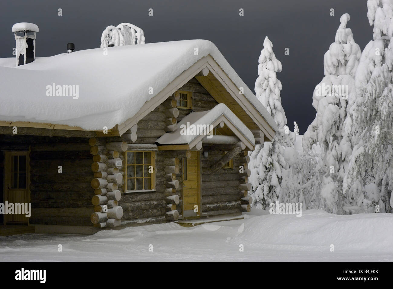 wooden cottage in the forest covered by snow Stock Photo - Alamy
