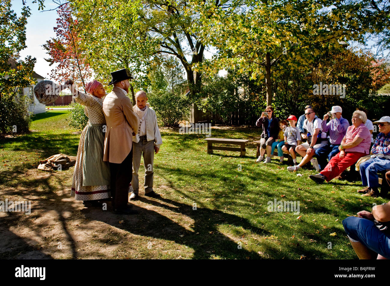Performers in period costume act out pre Civil War slave tales at a replica of slave quarters at Greenfield Village Dearborn MI Stock Photo