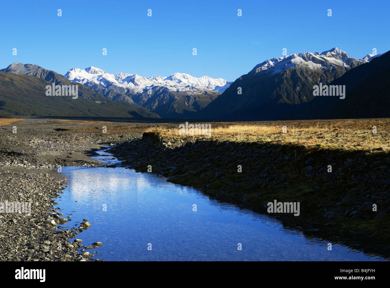 River in front of mountains Arthurs Pass National park South Island New Zealand Stock Photo