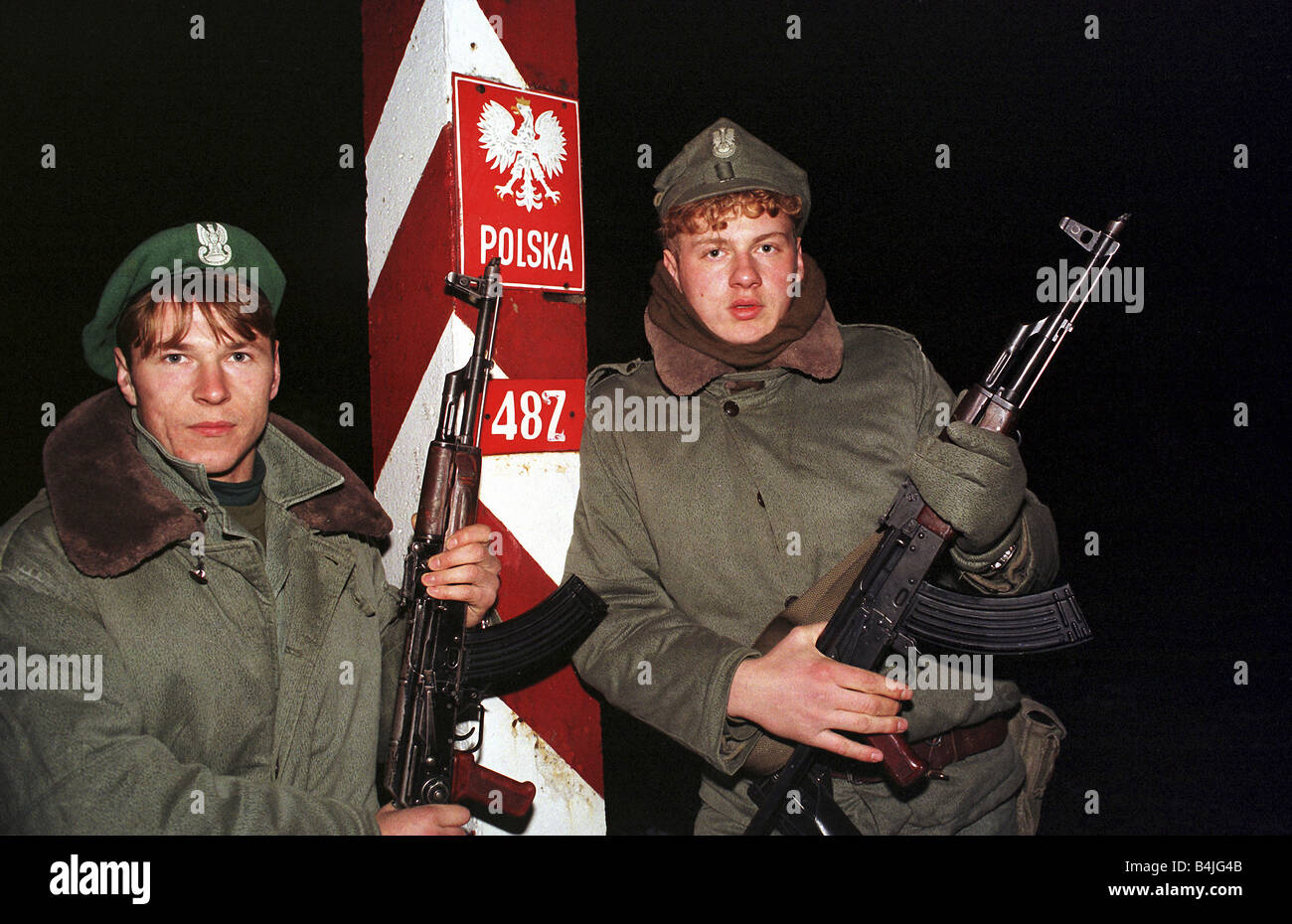 Polish border guard officers with guns on a night patrol at the Polish