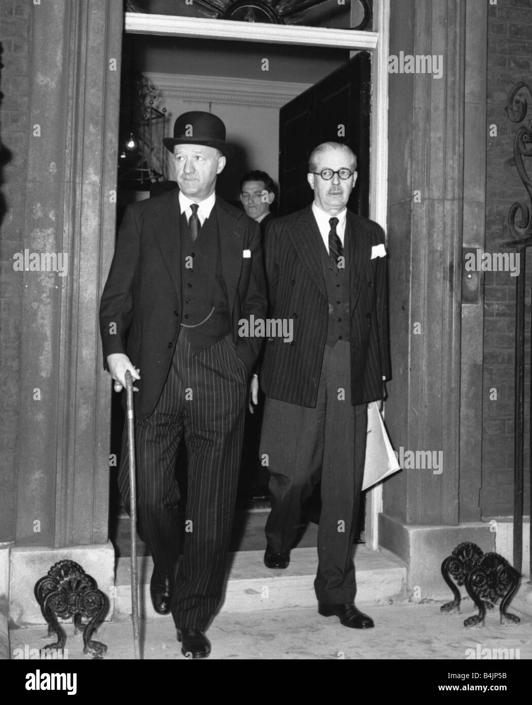 Suez Crisis 1956 Harold MacMillan and Rab Butler leaving 10 Downing Street after a pre Parliament meeting of cabinet ministers Stock Photo