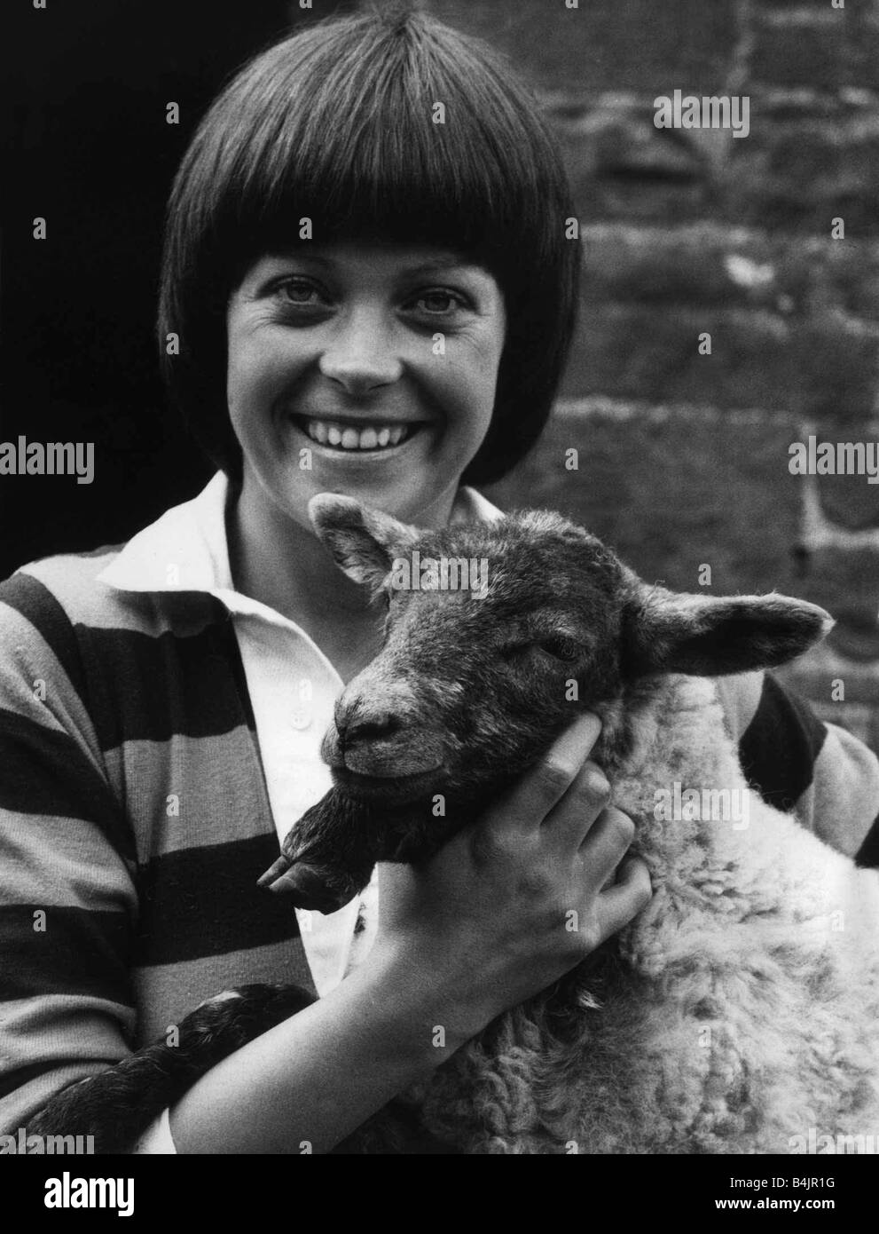 Isla St Clair actress with a lamb on location for the new series of The Farm June 1979 mdtgu Stock Photo