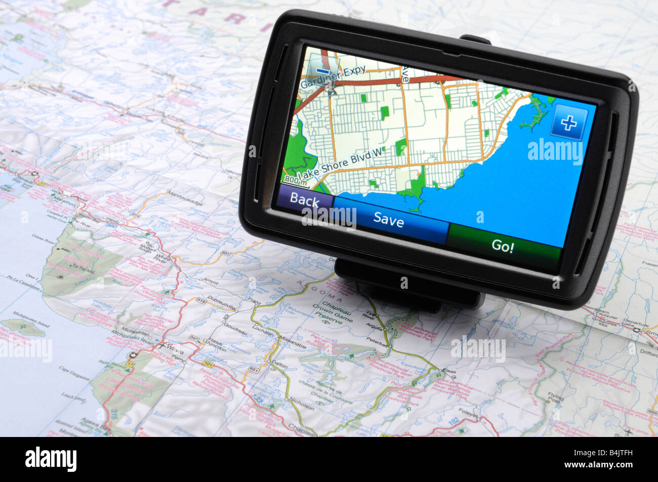 Automotive GPS device on a road map Stock Photo