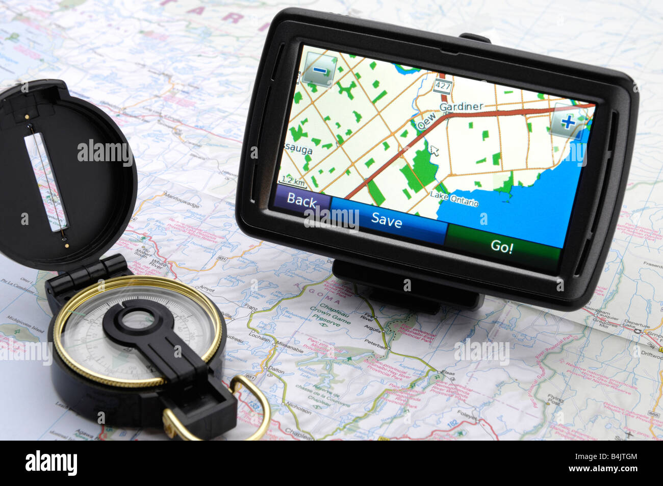 Automotive GPS device and a compass on a road map Stock Photo Alamy