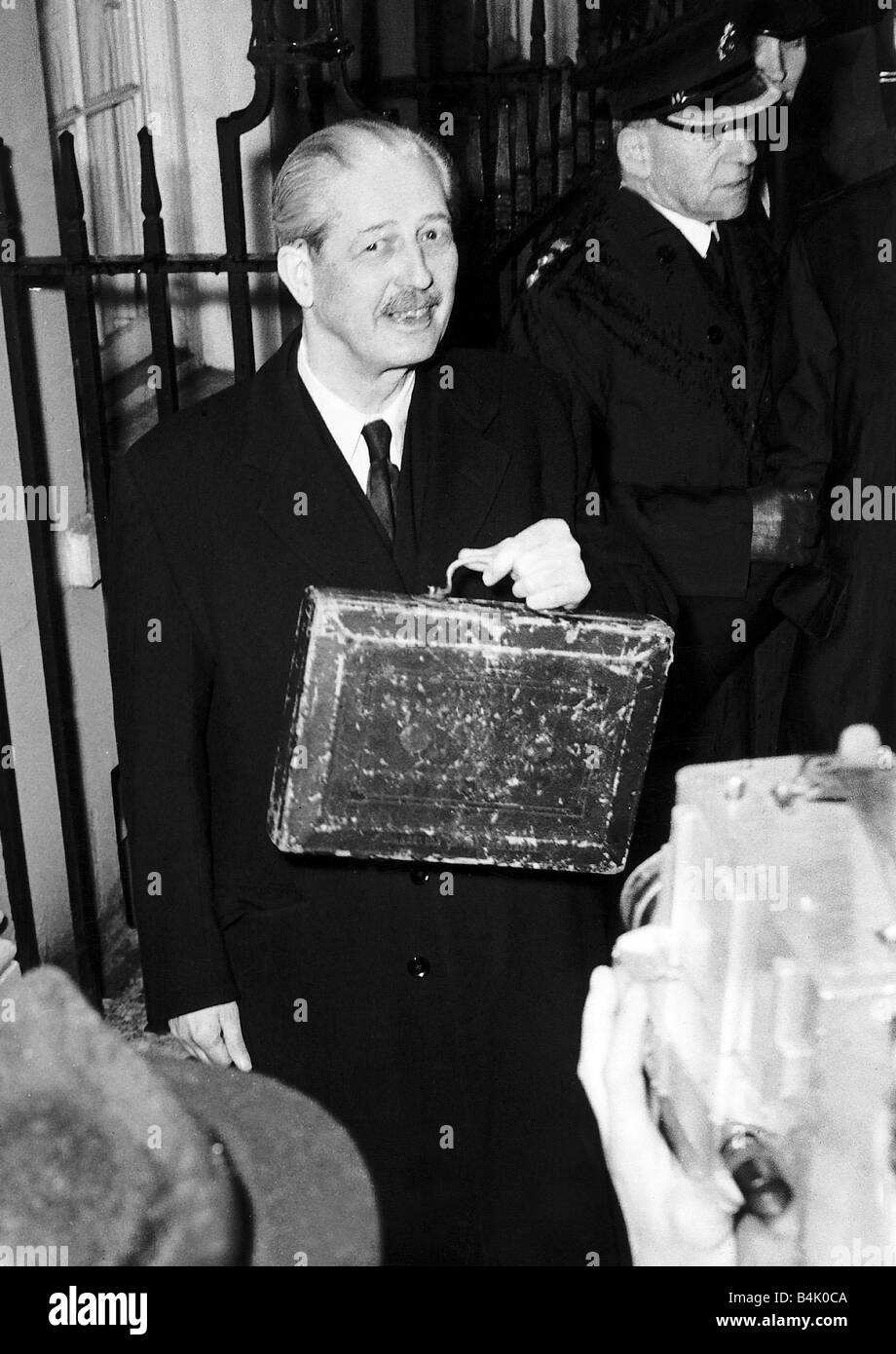 Harold MacMillan Chancellor of the Exchequer leaving Number 11 Downing Street with the historic dispatch box having earlier made his Budget speech in the House of Commons April 1956 Stock Photo