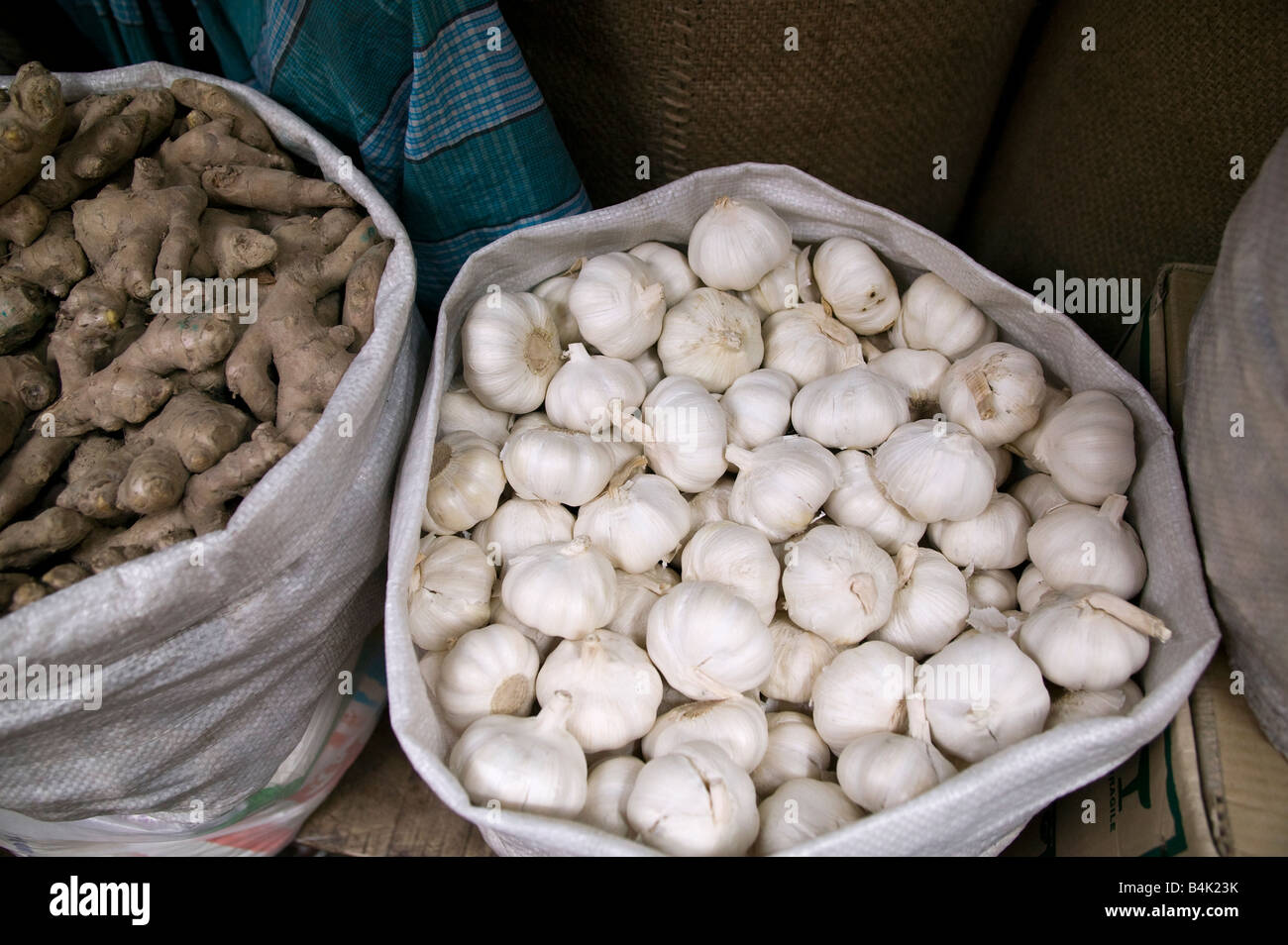 Bags of garlic bulbs and ginger for sale at a local market Dhaka