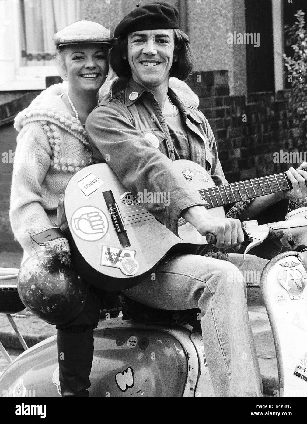 Robert Lindsay Actor October 1977 As Wolfie Citizen Smith sitting on a Motor Scooter holding a guitar with Cheryl Hall who plays his girlfriend in the BBC TV comedy series Citizen Smith dbase Stock Photo