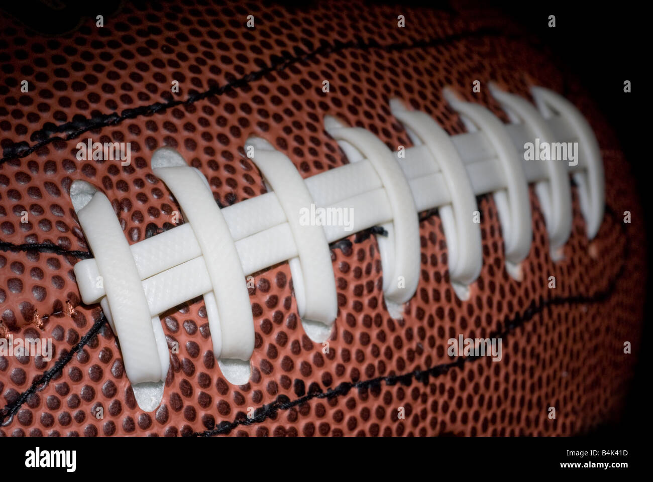 Thr threads of a new football show the intricate detail of the ball Stock Photo