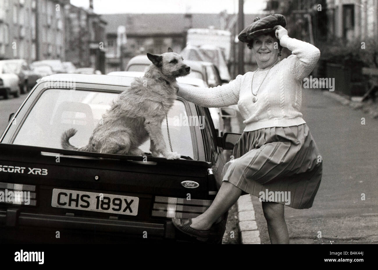 Old Lady With Her Dog On A Car Circa 1990 Stock Photo Alamy