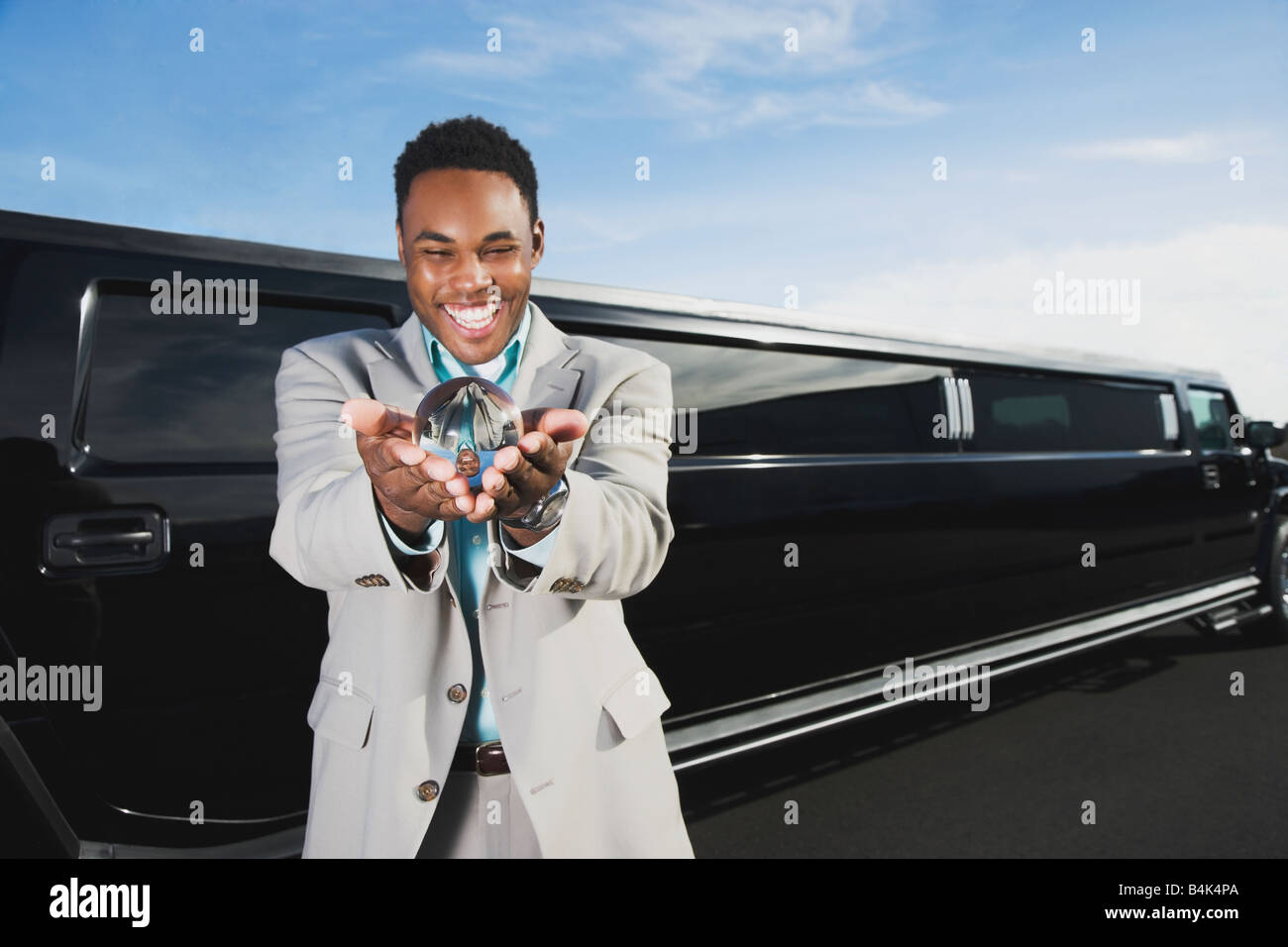 African businessman holding crystal ball Stock Photo - Alamy
