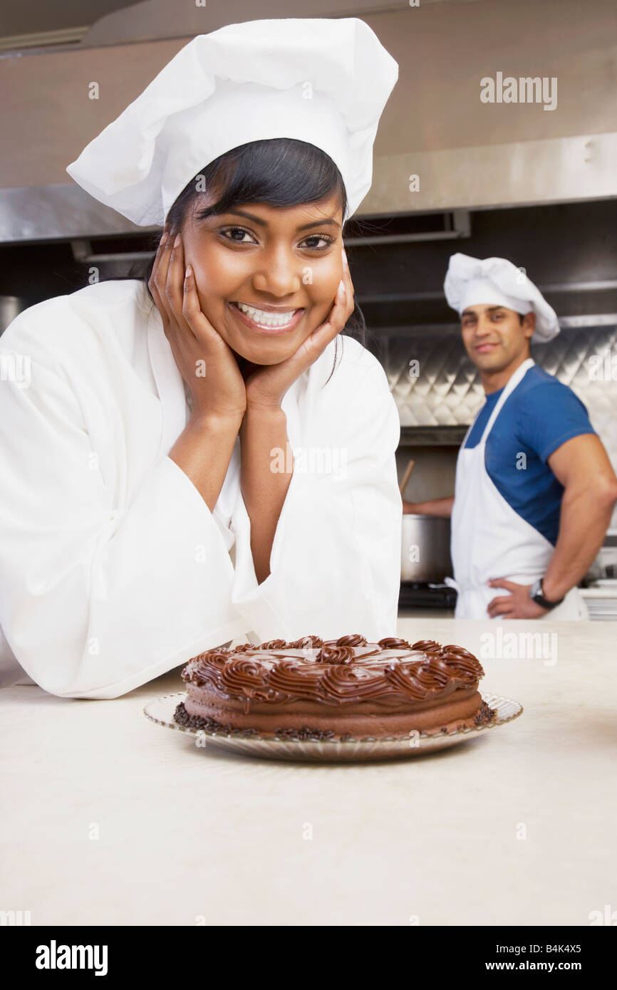 Mixed Race female pastry chef with cake Stock Photo Alamy