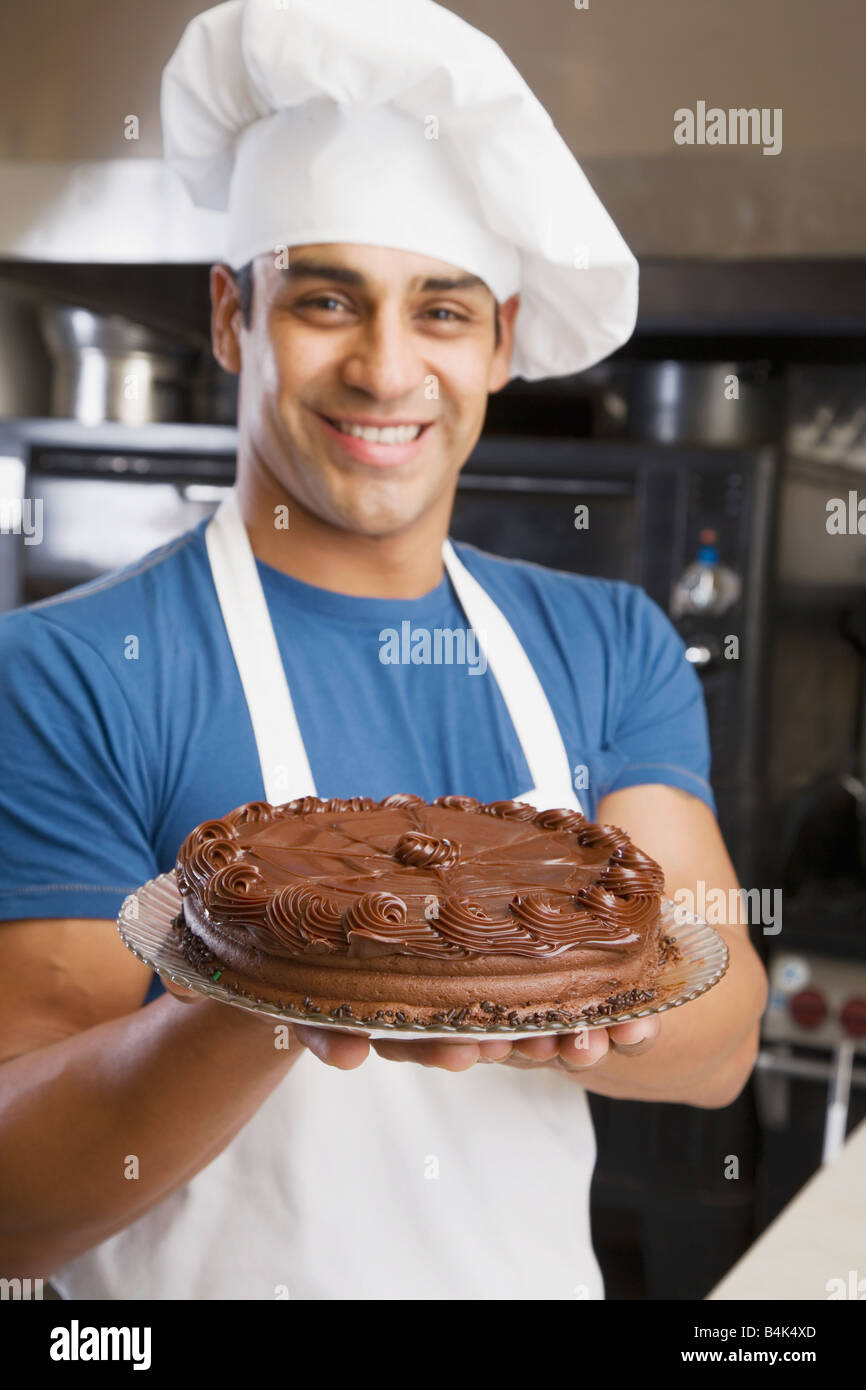 Hispanic male pastry chef holding cake Stock Photo Alamy