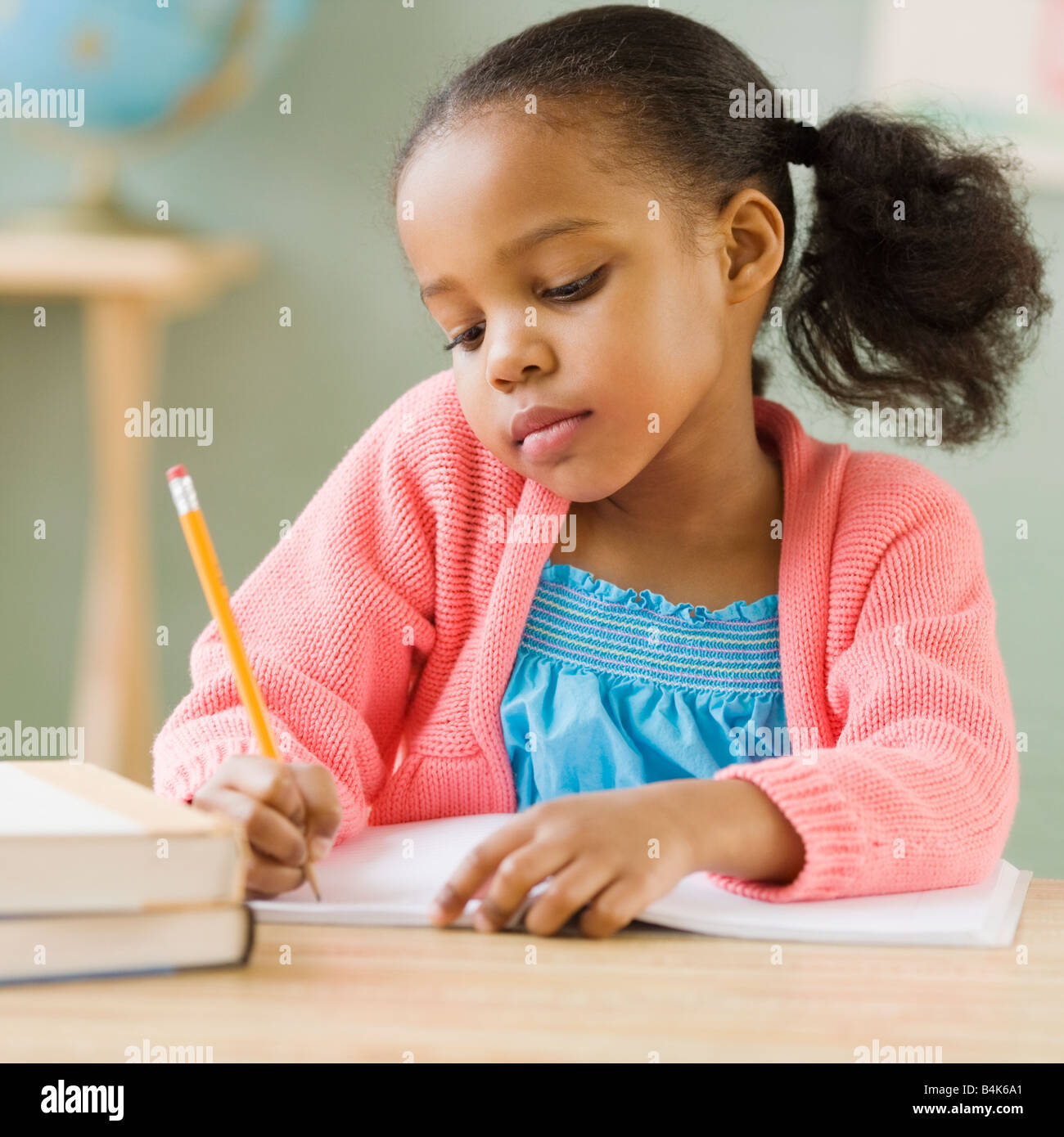 Mixed race girl doing school work Stock Photo