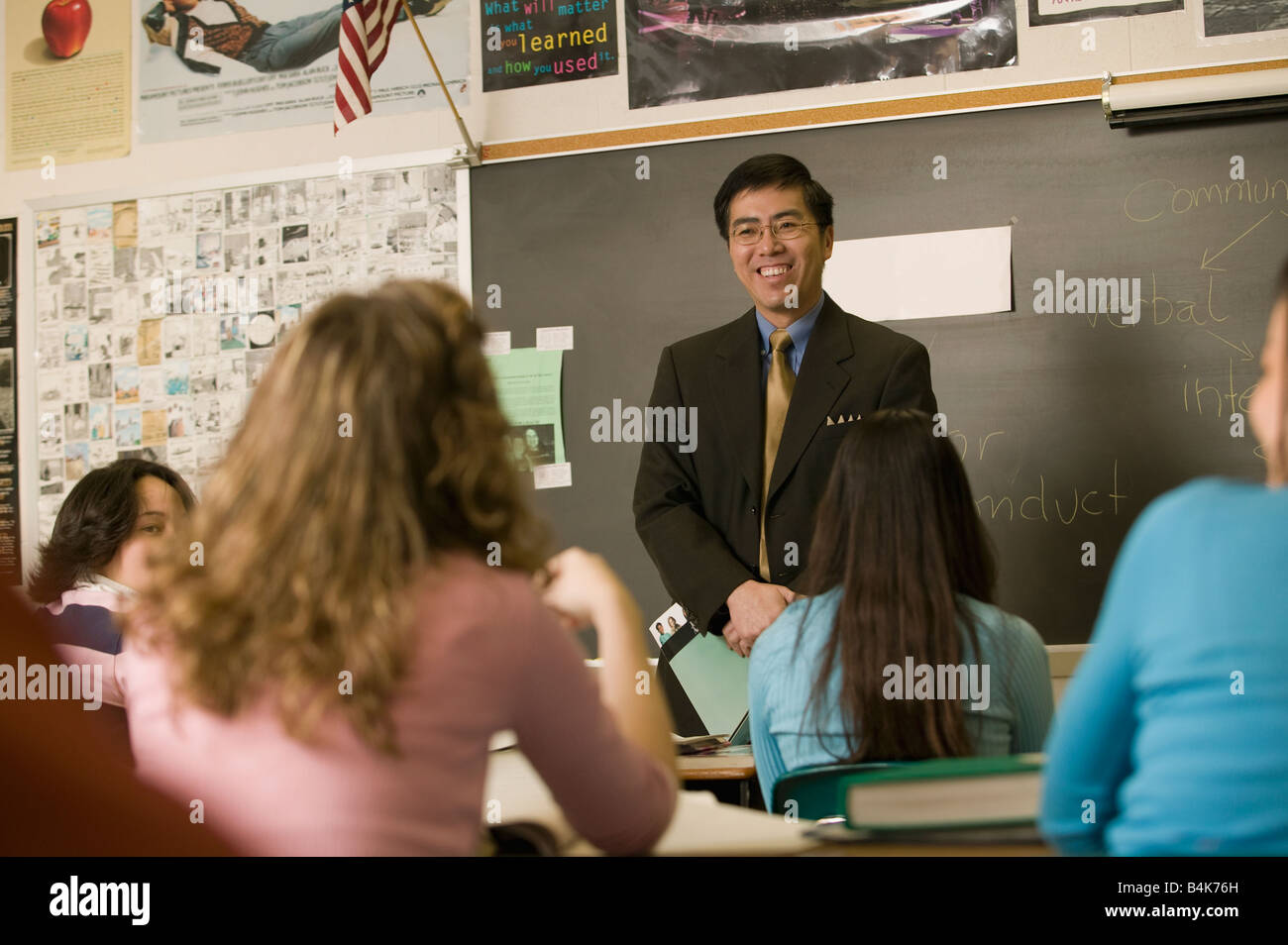 Asian teacher talking to students in classroom Stock Photo - Alamy