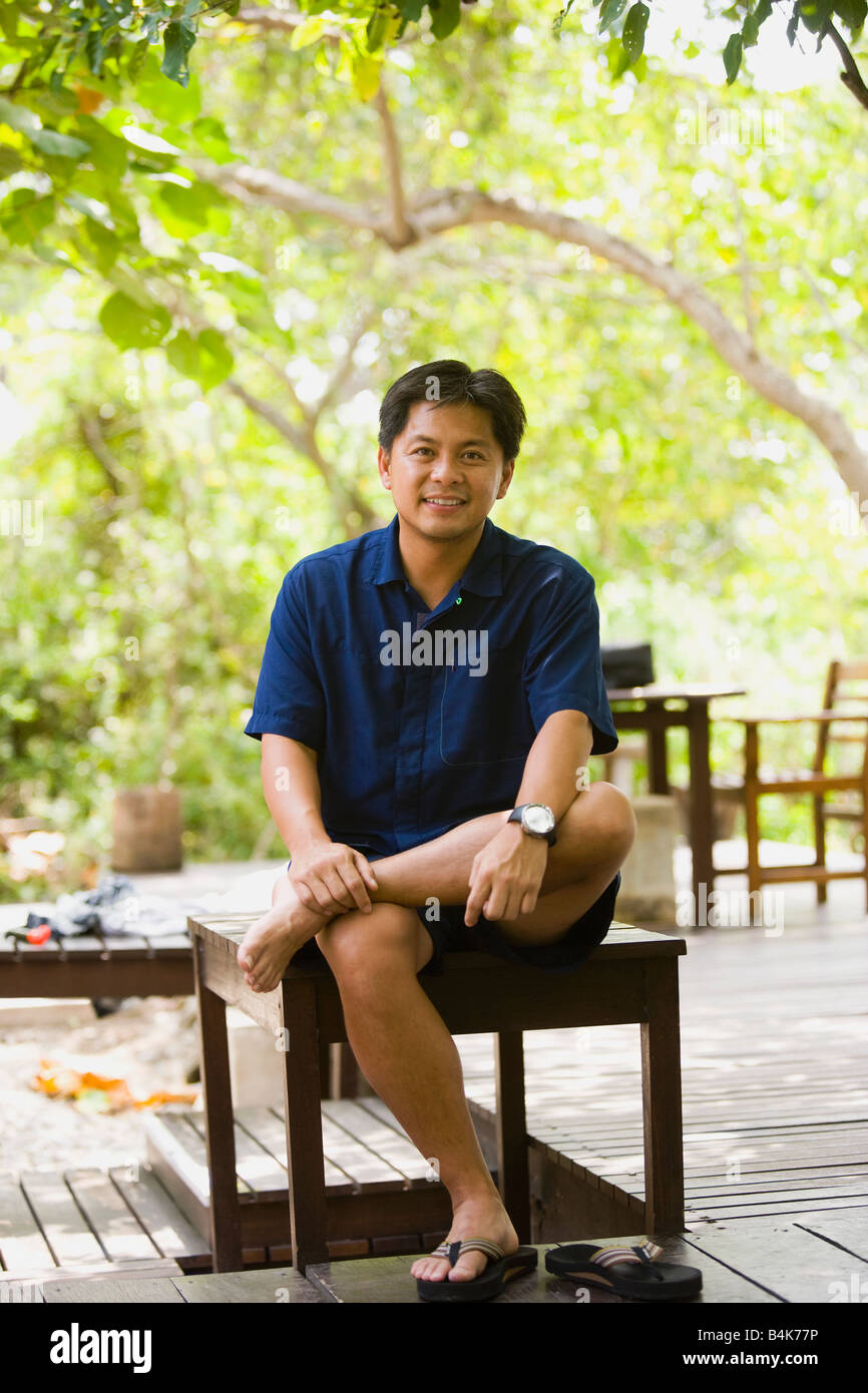 Barefoot man sitting bench hi-res stock photography and images - Alamy