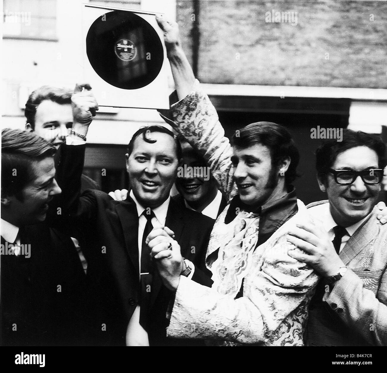 Bill Haley of the Comets on a tour of Britain is presented by Freddie Lee with an original 78rpm record of his 1950s 20 million Stock Photo