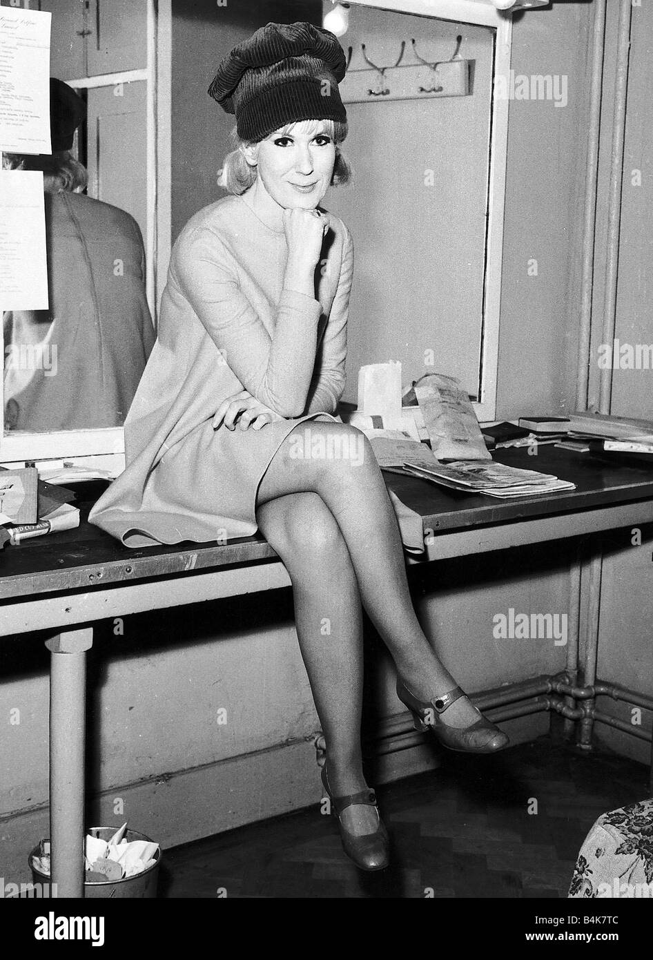 Dusty Springfield pop singer sitting on a table Stock Photo - Alamy