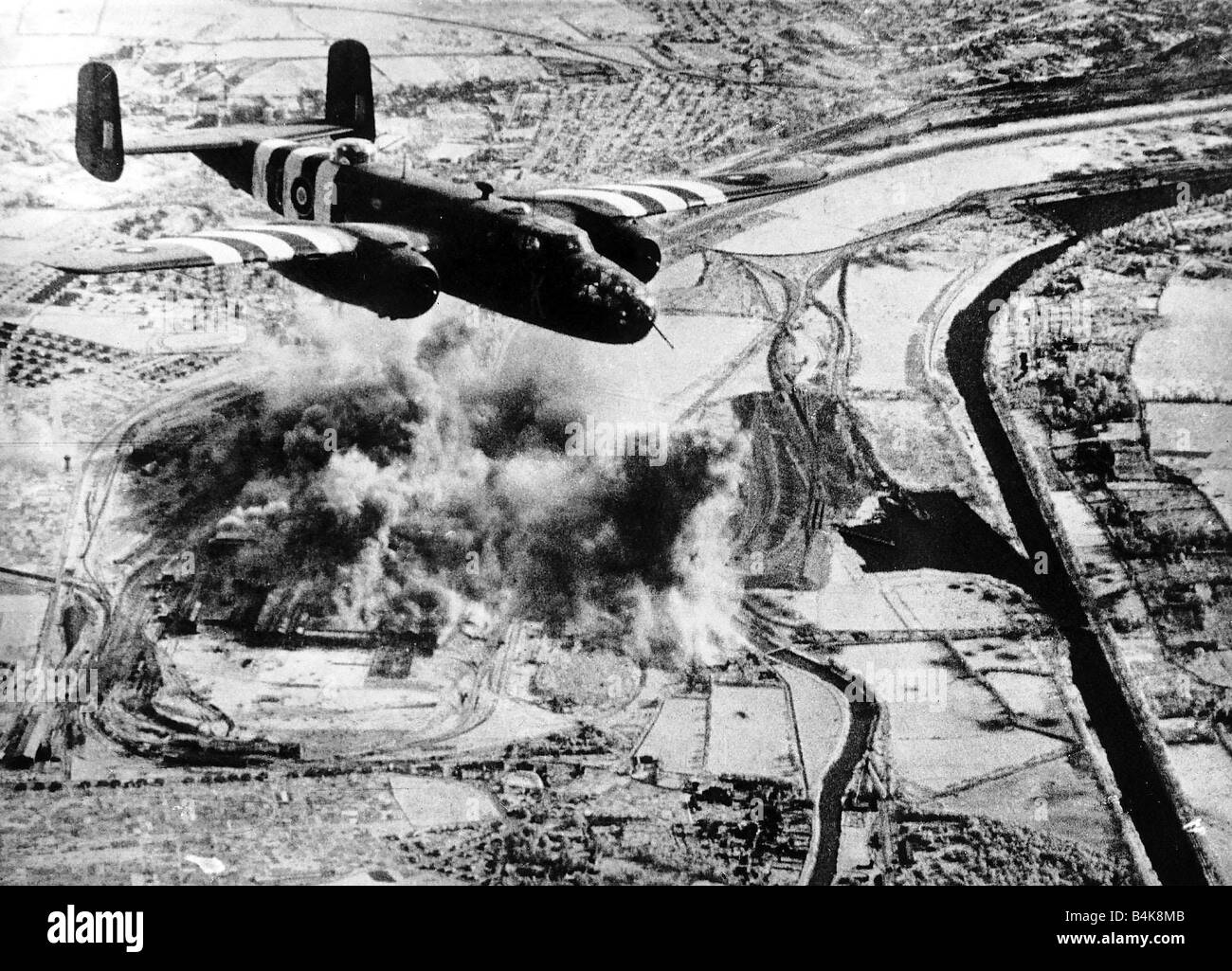 An RAF Mitchell B25 bombs the steel works in Caen Normandy Smoke is