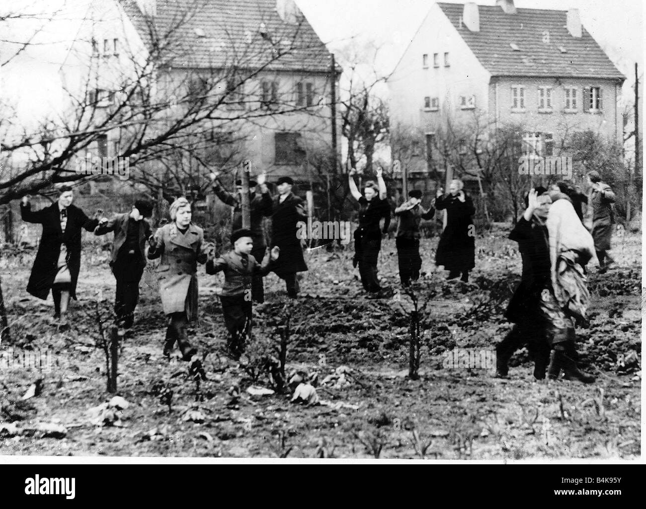 WW2 March 1945 German civilians emerge from their homes as the 35th U S Infantry Division occupy Lindforth Germany Stock Photo
