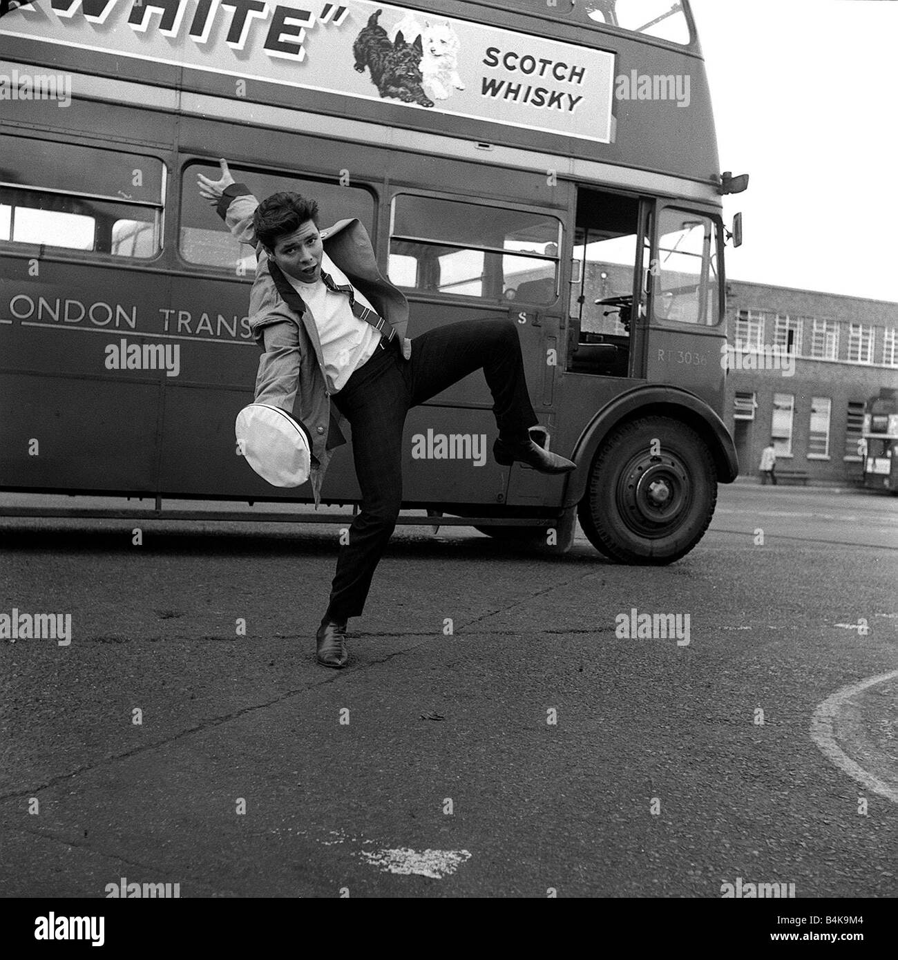 Cliff Richard prepares for his ne role in Summer Holiday by taking control of a 7 5 ton red bus at Chiswich London Transport driving school 07 05 62 Q3930 y2k The plot A double decker tour bus on a trip to Athens collides with a car carrying three female musicians Later the bus picks up a winsome young boy Lauri Peters who turns out to be an incognito American songstress Barbara who is trying to hide out from her overbearing mother and overzealous agent The bus doesn t go too far before she and the bus mechanic Don Cliff Richard fall in love Many musical interludes spice up this romantic tale Stock Photo