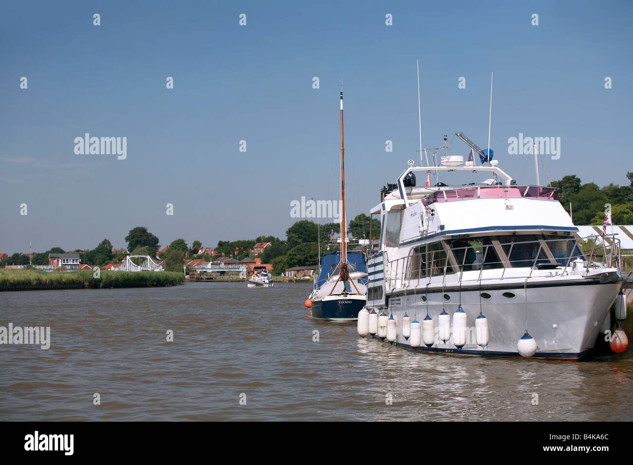 A view of the village of Reeham on the Norfolk Broads approaching on the River Yare from the Great Yarmouth side Stock Photo