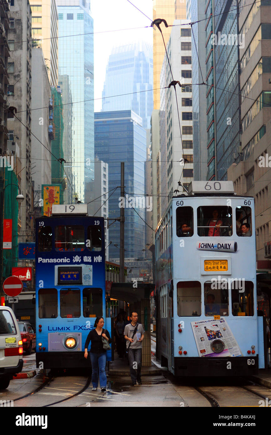 Two trams in Hong Kong with the IFC Tower in the background Stock Photo