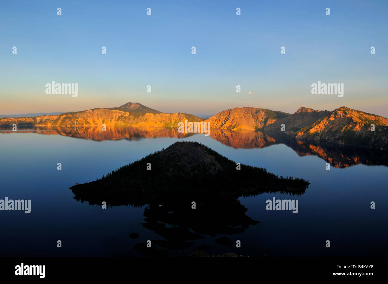 The Crater Lake and the Wizard Island at sunset. The Crater Lake National Park, Oregon, USA. Stock Photo