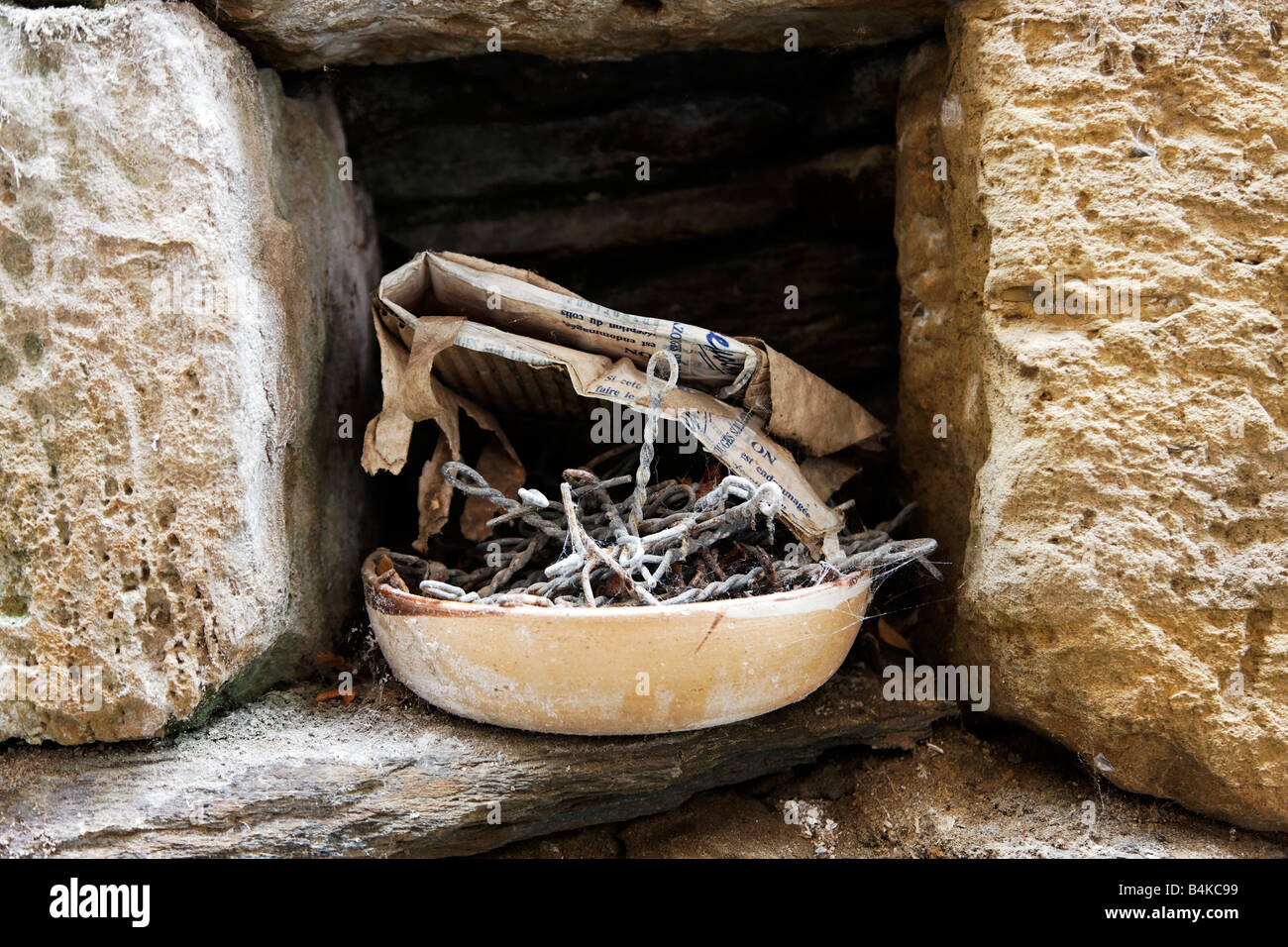 Old metal and newspaper in a small window Stock Photo