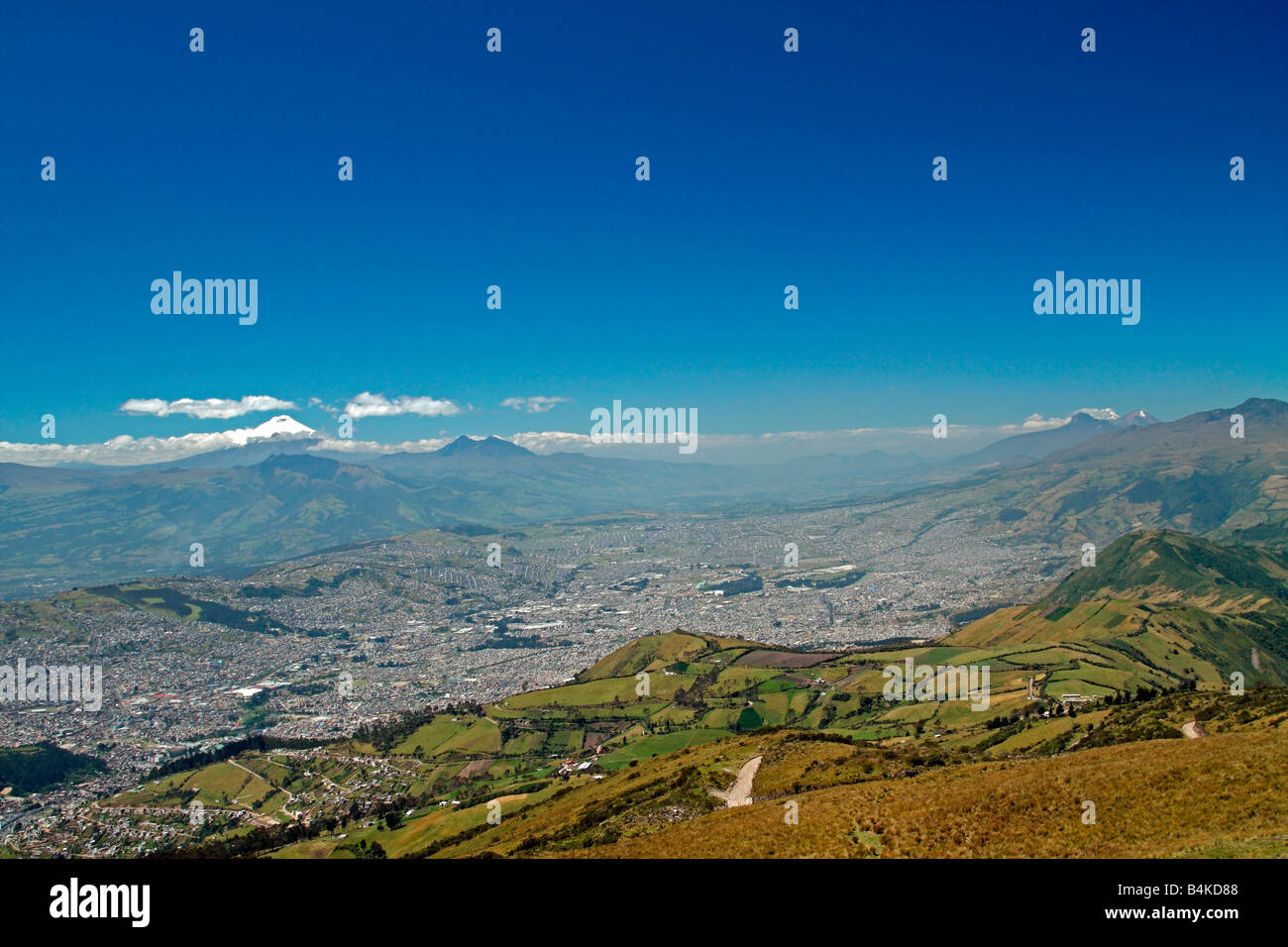 View of Quito and the volcanoes Cotopaxi and Iliniza, from summit of Pichincha volcano, Quito, Ecuador. Stock Photo