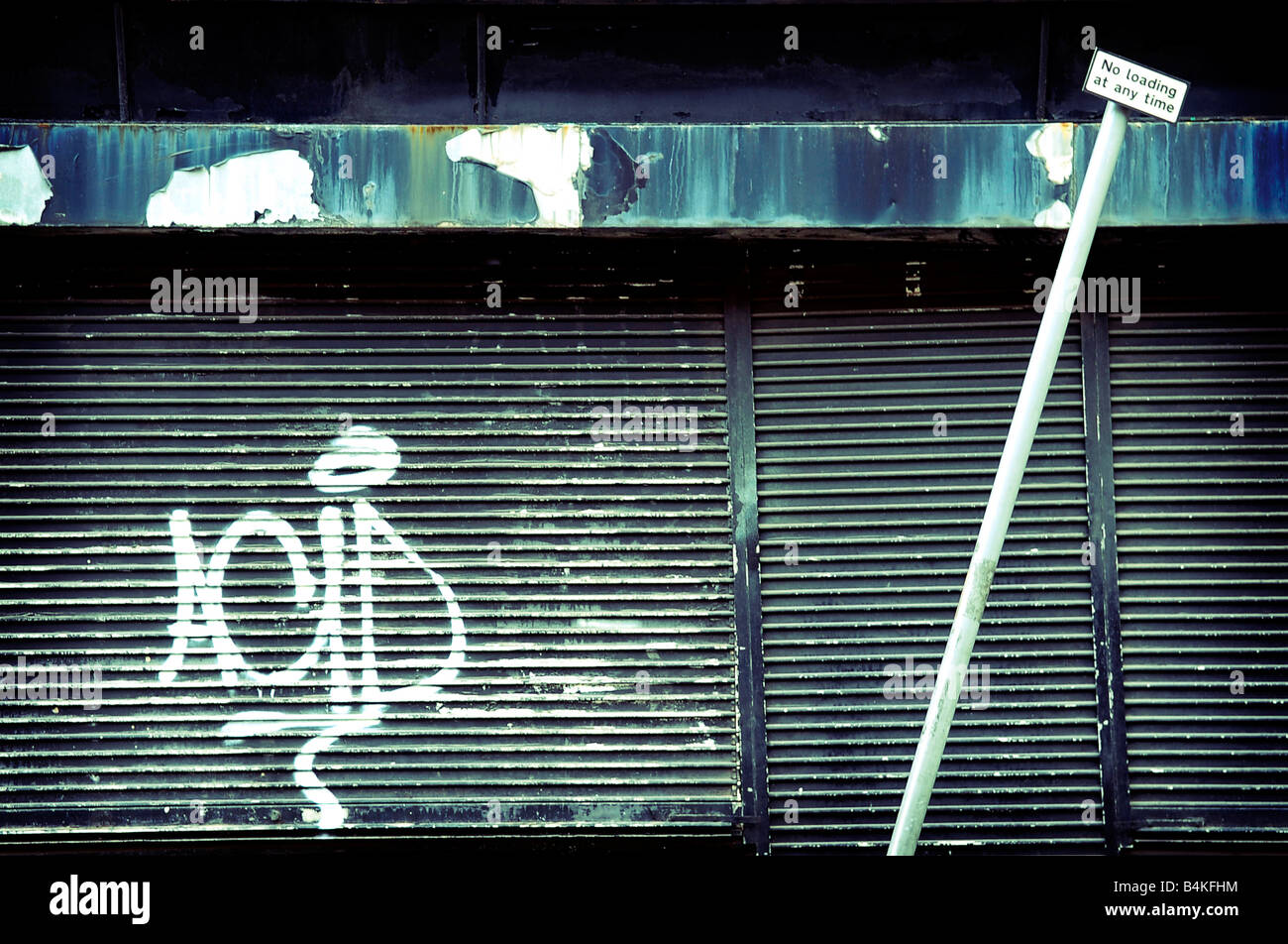 acid graffiti shutters black closed shop store thomas street northern quarter manchester pavement street urban city uk england Stock Photo