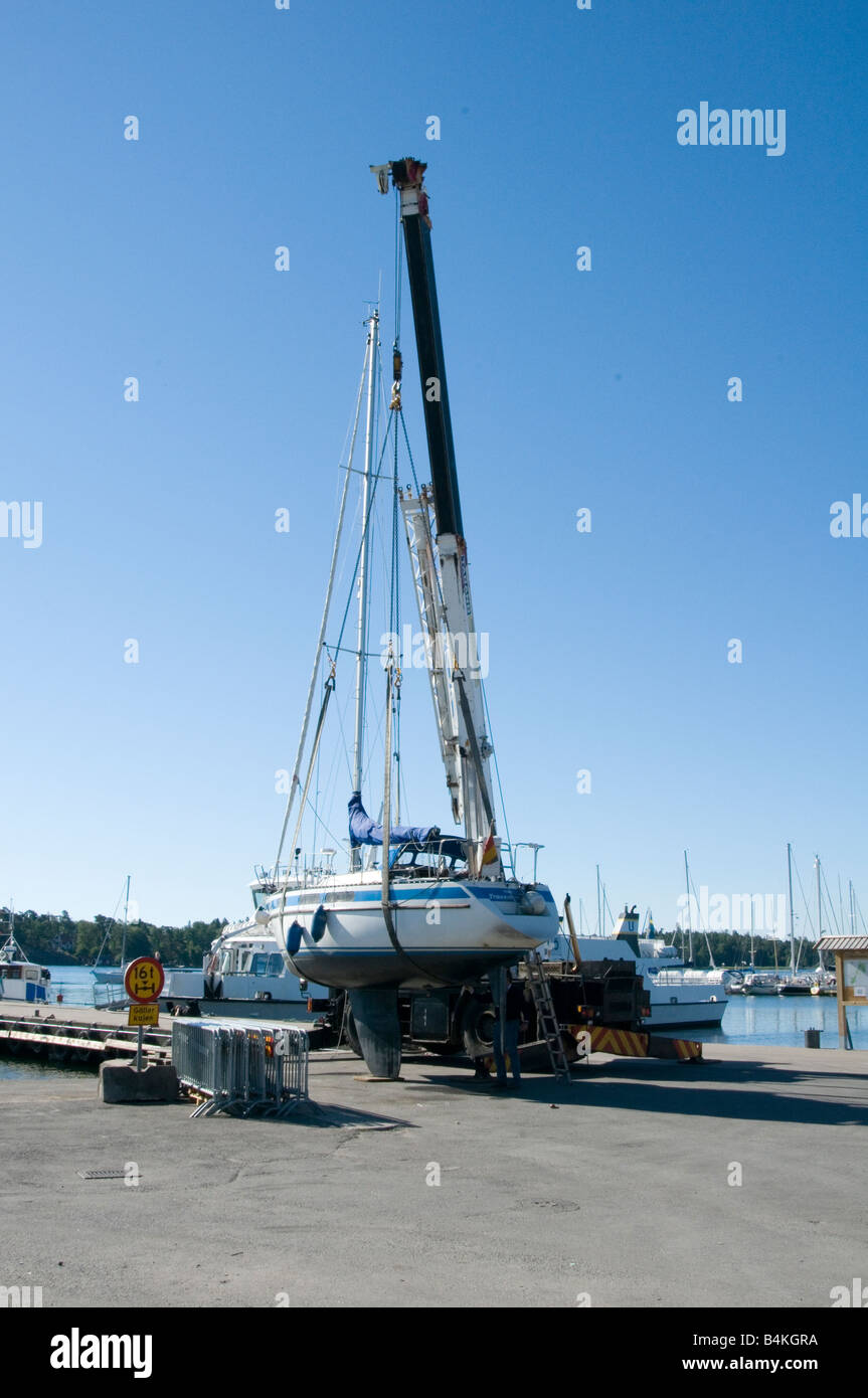 boat boats dry dock crane lift lifting out of the water lifted