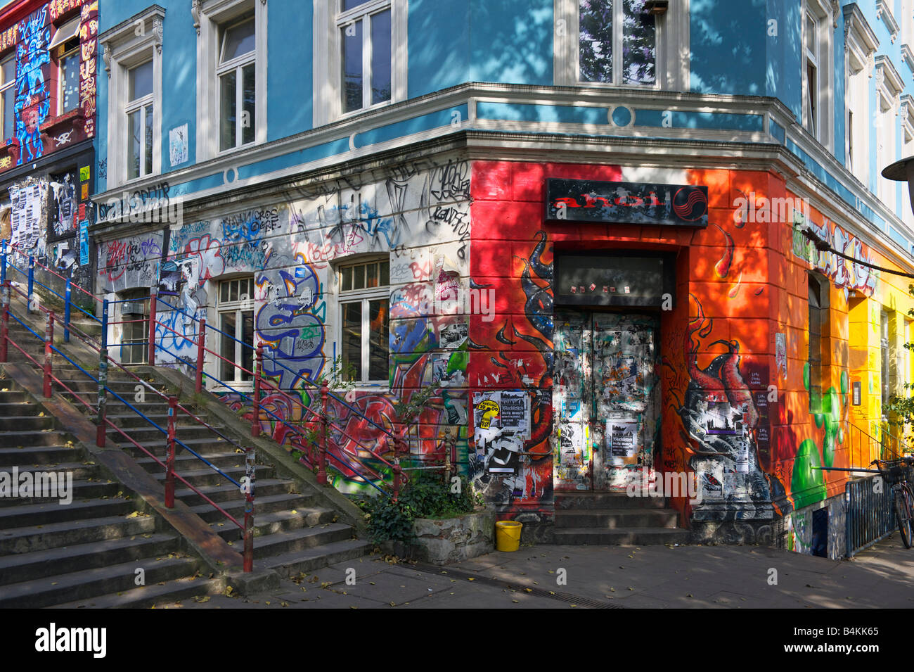 Graffiti and wall art cover a shop and apartments in the St Pauli district of Hamburg Germany Stock Photo