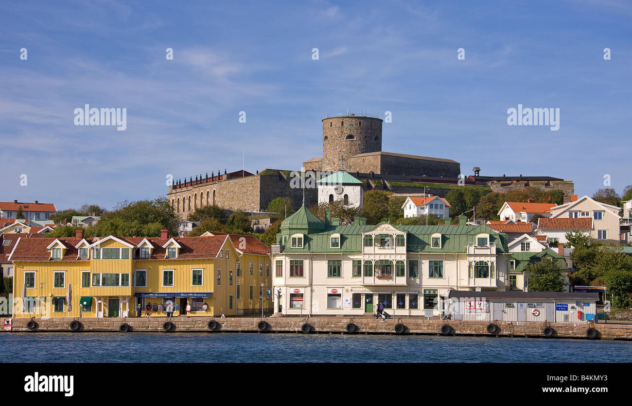 A view across the strait to Marstrand Quay  and the pretty village and the dominant stone castle above it. Stock Photo