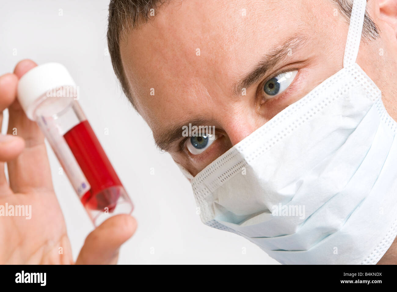 Close up of a male doctor looking at a blood sample Stock Photo