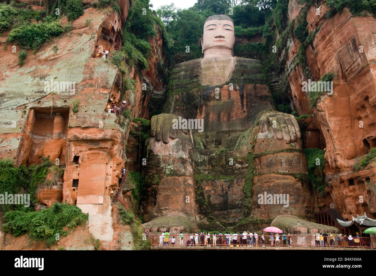 Tourists look up at the Giant Buddha of Leshan, China.  A UNESCO World Heritage Site Stock Photo