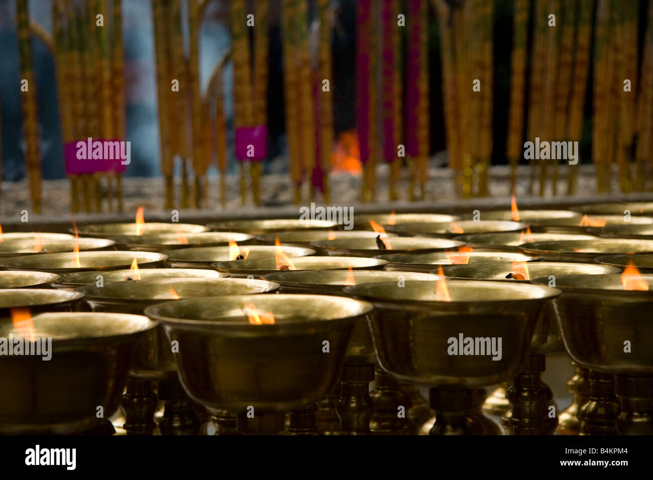 Brass cups are used as oil burners in a Chinese temple, Leshan, China Stock Photo