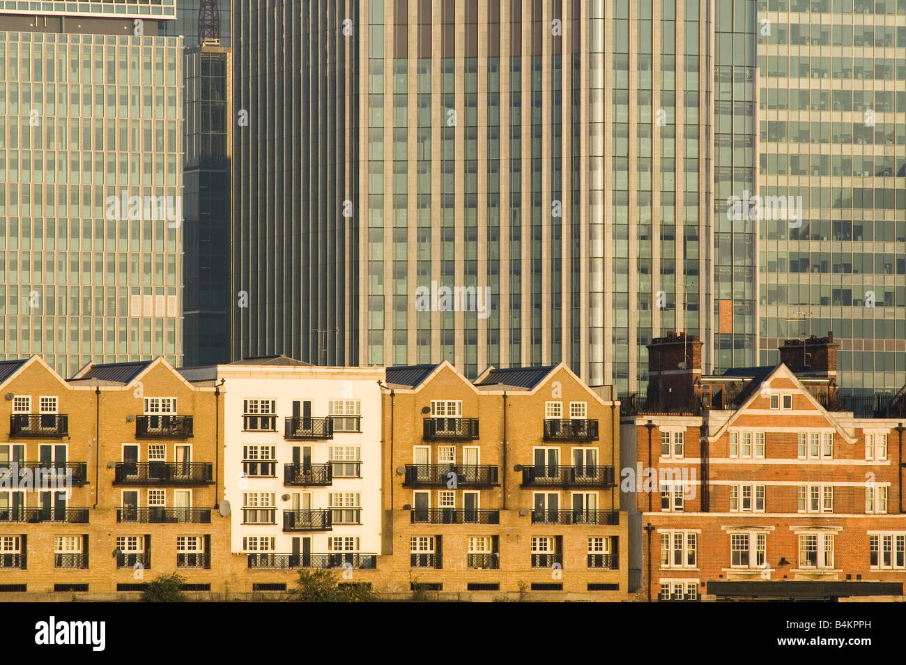 Houses in front of Canary Wharf skyscrapers. Docklands London Stock ...