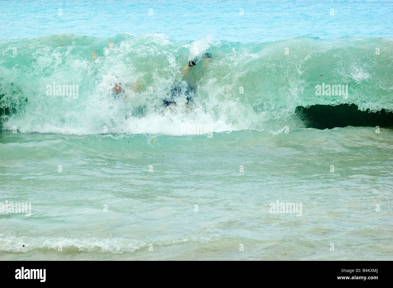 young boys body surfing at Little Maho Bay, St. John, USVI Stock Photo