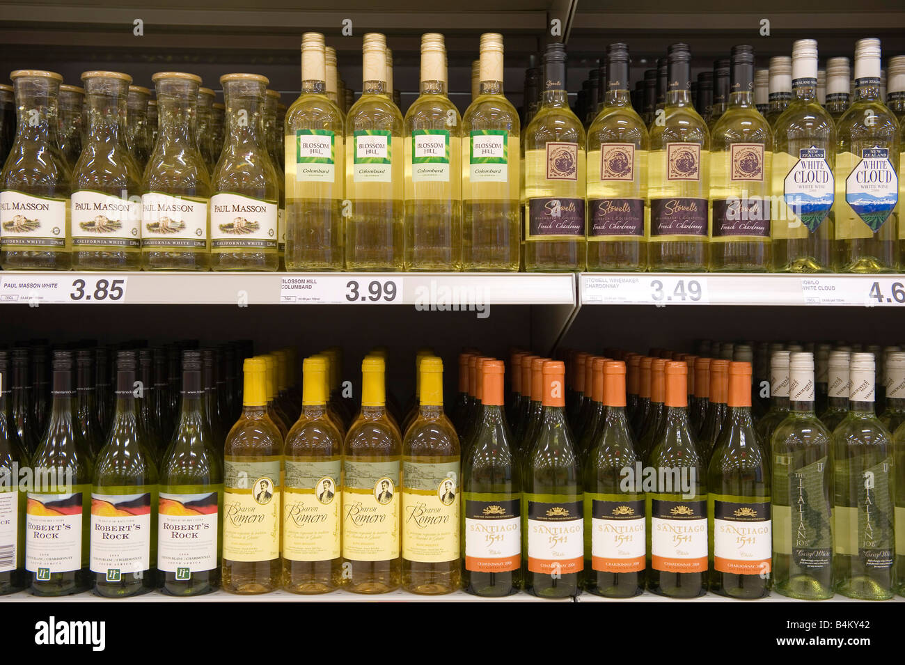 Bottles of cheap white wine on shelves in a budget supermarket in the UK Stock Photo